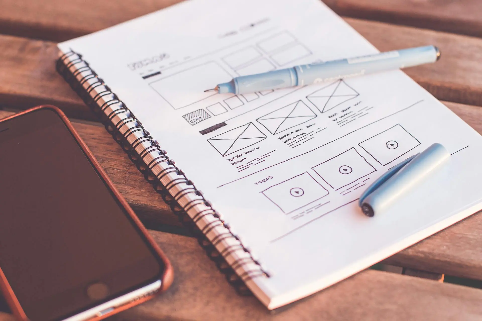 notebook-beside-the-iphone-on-table